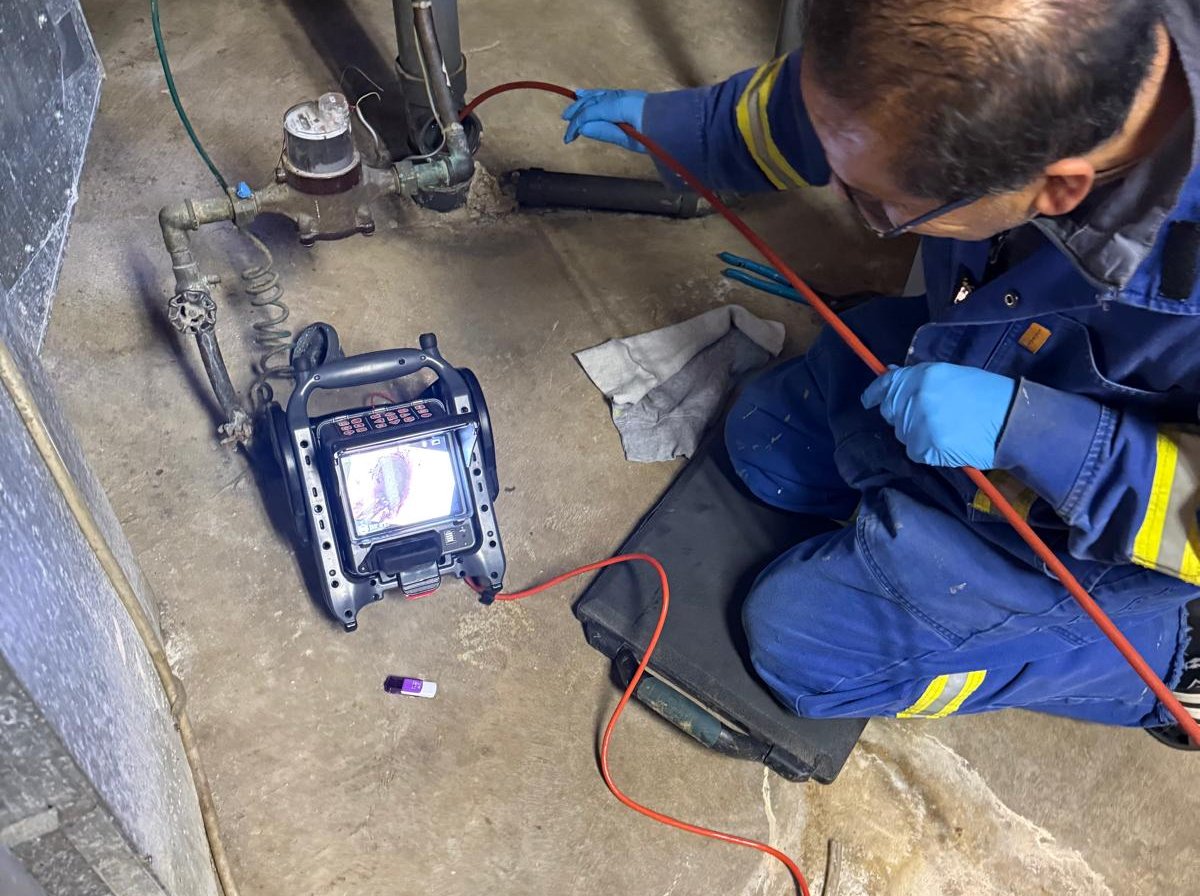 Technician running a drain inspection camera in an Edmonton basement
