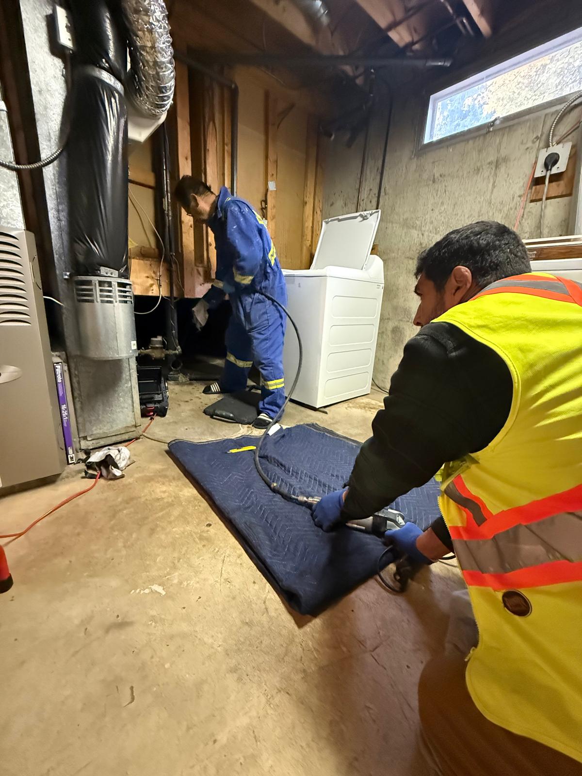 Instarooter technicians clearing a sewer line in an Edmonton basement